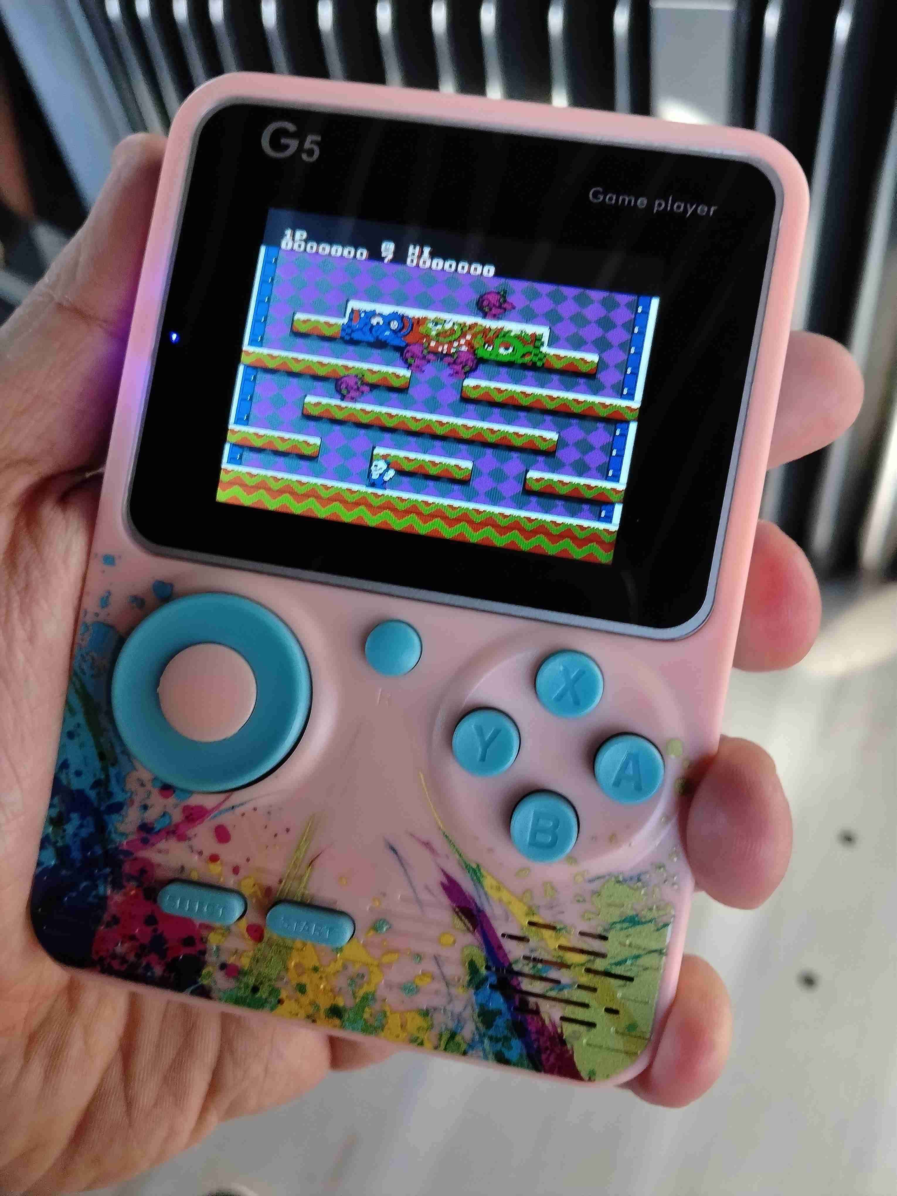 Consola de juegos portátil G5 rosada juegos de nes