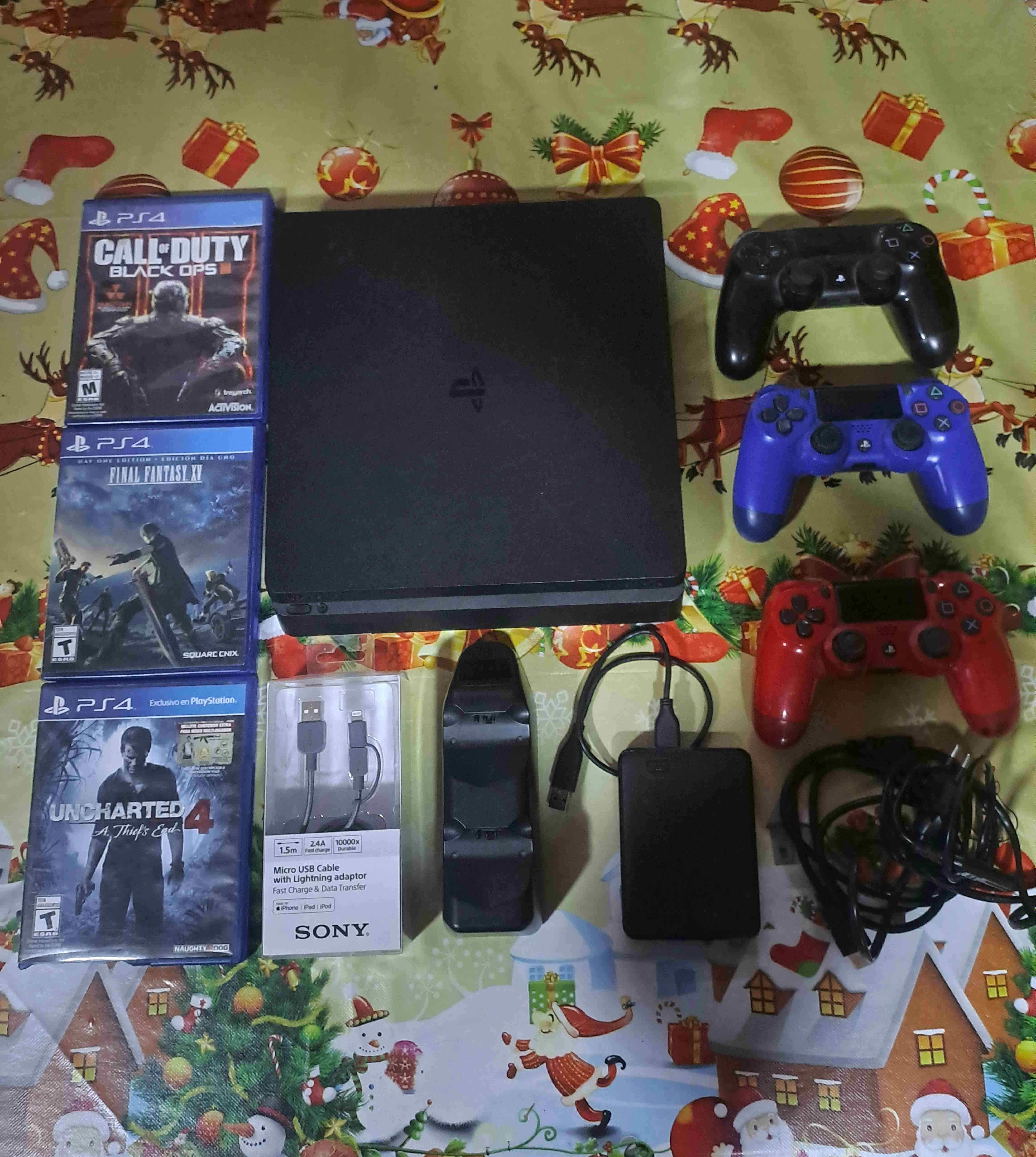 Consola PS4 con juegos y controles - miniatura 1