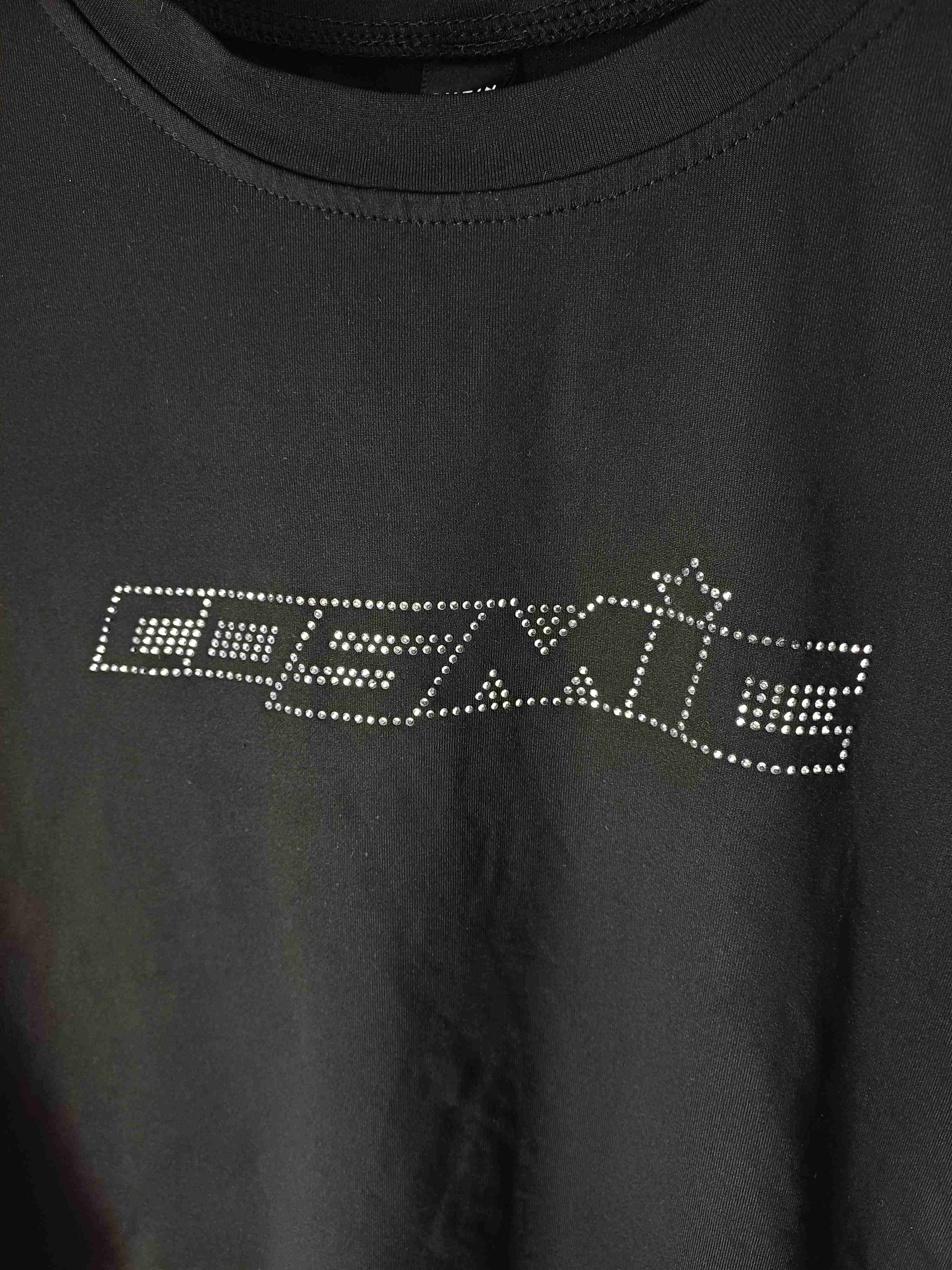 Polera negra con diseño brillante "cosmic" - miniatura 1